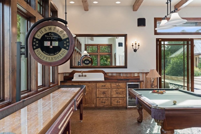 601 Crystal Creek Dr, Austin, TX 78746 - playroom with wine cooler, beamed ceiling, plenty of natural light, billiards, and recessed lighting