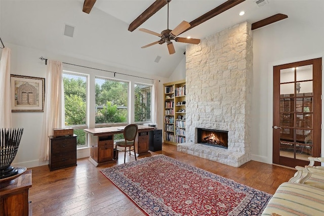 601 Crystal Creek Dr, Austin, TX 78746 - office with ceiling fan, a stone fireplace, beam ceiling, wood-type flooring, and high vaulted ceiling