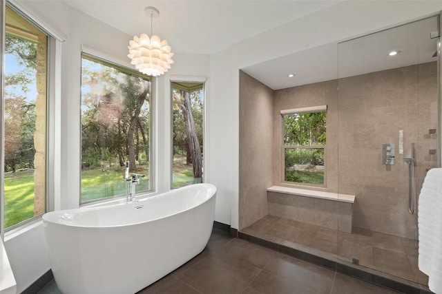 601 Crystal Creek Dr, Austin, TX 78746 - full bath with a soaking tub, plenty of natural light, and tiled shower
