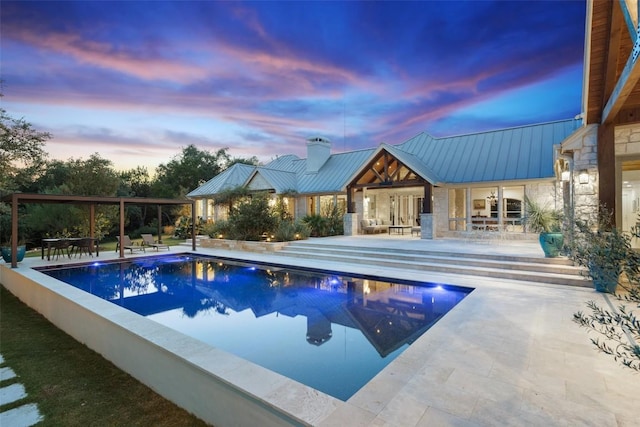601 Crystal Creek Dr, Austin, TX 78746 - pool at dusk featuring a patio area and an outdoor pool