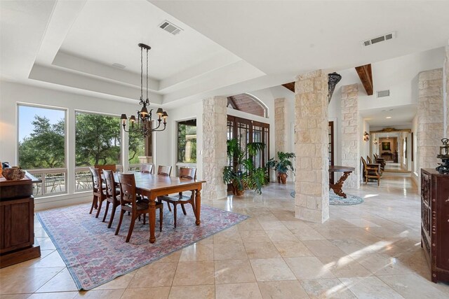 601 Crystal Creek Dr, Austin, TX 78746 - dining space with decorative columns, a chandelier, and a tray ceiling