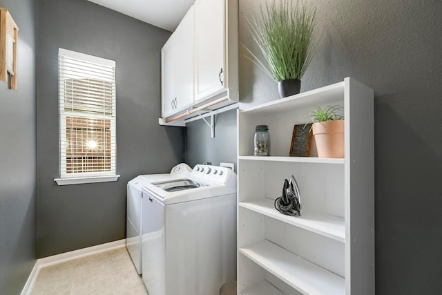 250 Lexington Dr, Austin, TX 78737 - washroom featuring washing machine and clothes dryer, cabinet space, and light tile patterned floors