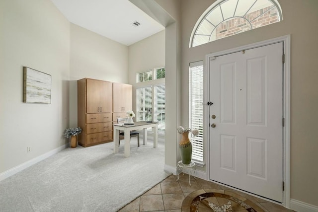 250 Lexington Dr, Austin, TX 78737 - entrance foyer featuring a towering ceiling, healthy amount of natural light, light tile patterned floors, and light colored carpet