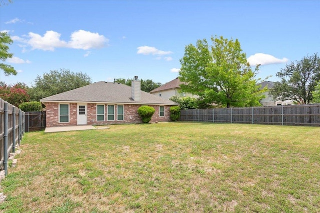 1811 Indian Summer Pass, Round Rock, TX 78665 - rear view of property with brick siding, a fenced backyard, a patio area, and a chimney