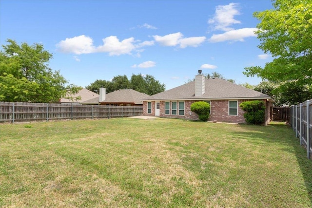 1811 Indian Summer Pass, Round Rock, TX 78665 - rear view of property with a fenced backyard, brick siding, and a chimney