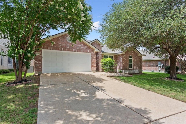 1811 Indian Summer Pass, Round Rock, TX 78665 - view of front of property with brick siding, a front yard, driveway, and a garage