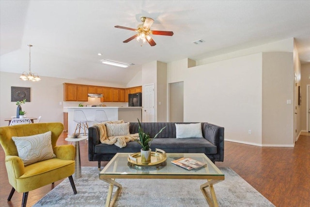 1811 Indian Summer Pass, Round Rock, TX 78665 - living room featuring lofted ceiling, a ceiling fan, wood finished floors, and a chandelier