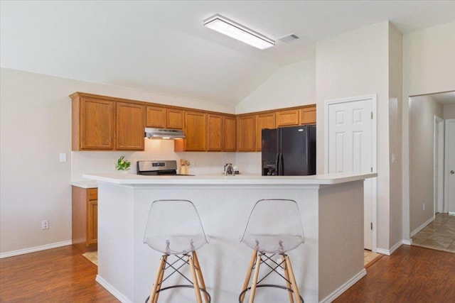 1811 Indian Summer Pass, Round Rock, TX 78665 - kitchen featuring black fridge with ice dispenser, under cabinet range hood, electric stove, lofted ceiling, and wood finished floors