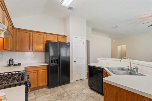 1811 Indian Summer Pass, Round Rock, TX 78665 - kitchen with black appliances, backsplash, brown cabinetry, light countertops, and vaulted ceiling