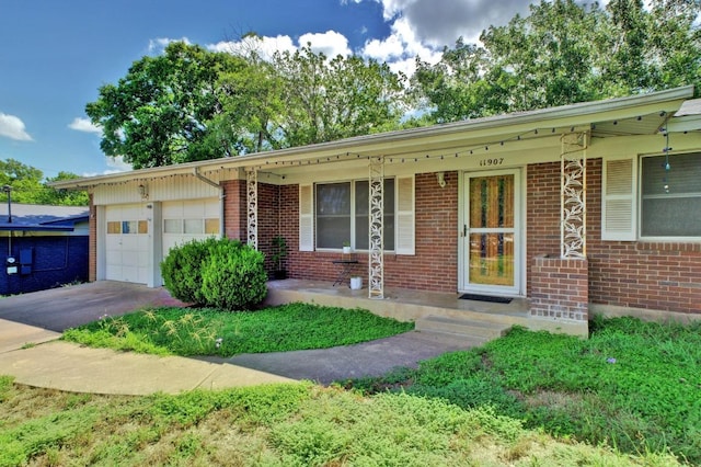 11907 Oak Trl, Austin, TX 78753 - single story home with a garage, brick siding, concrete driveway, and covered porch