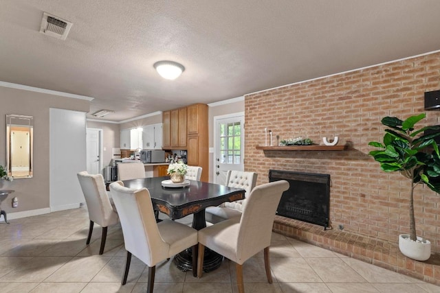 11907 Oak Trl, Austin, TX 78753 - dining space featuring light tile patterned flooring, a fireplace, crown molding, and a textured ceiling