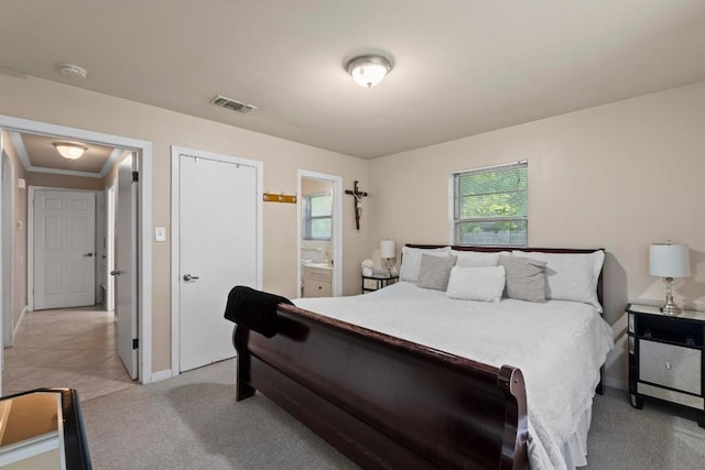 11907 Oak Trl, Austin, TX 78753 - bedroom with multiple windows, light colored carpet, connected bathroom, and ornamental molding