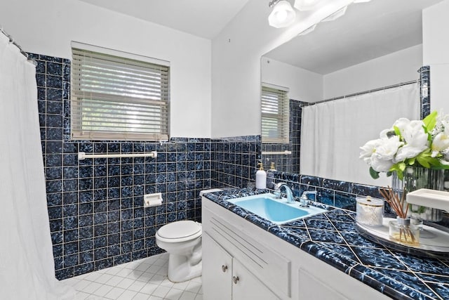 11907 Oak Trl, Austin, TX 78753 - bathroom with tile patterned flooring, vanity, tile walls, a wainscoted wall, and a shower with shower curtain