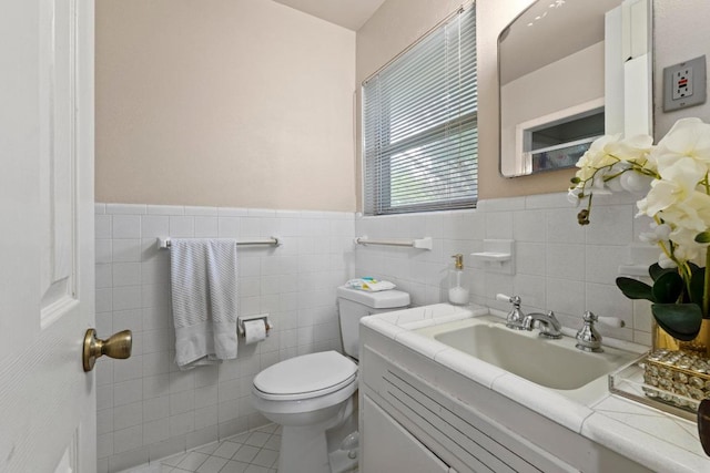 11907 Oak Trl, Austin, TX 78753 - half bath with vanity, tile walls, a wainscoted wall, and tile patterned floors