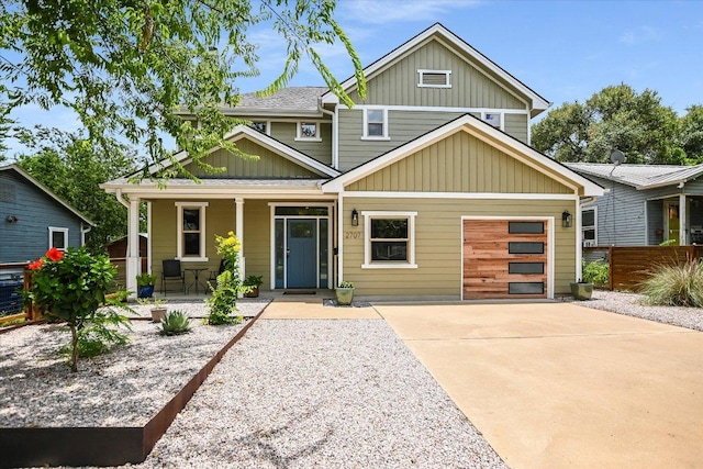2707 La Mesa Dr, Austin, TX 78704 - view of front of property featuring covered porch, driveway, board and batten siding, and an attached garage