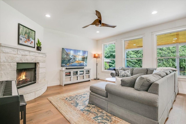 2707 La Mesa Dr, Austin, TX 78704 - living room featuring wood finished floors, ceiling fan, a stone fireplace, and recessed lighting