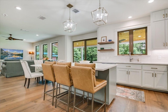 2707 La Mesa Dr, Austin, TX 78704 - kitchen featuring open floor plan, a chandelier, tasteful backsplash, light countertops, and pendant lighting