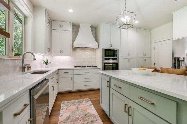 2707 La Mesa Dr, Austin, TX 78704 - kitchen with custom exhaust hood, stainless steel appliances, decorative backsplash, white cabinets, and recessed lighting