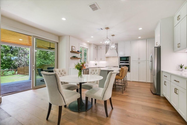 2707 La Mesa Dr, Austin, TX 78704 - dining area with healthy amount of natural light, recessed lighting, light wood-type flooring, and a chandelier
