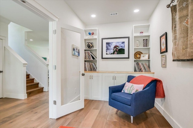 2707 La Mesa Dr, Austin, TX 78704 - sitting room with light wood-style flooring, stairway, built in shelves, and recessed lighting
