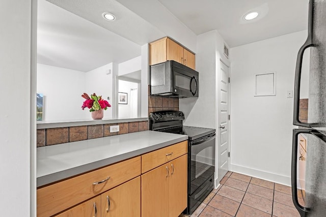 3815 Guadalupe St Unit 112, Austin, TX 78751 - kitchen featuring black appliances, light tile patterned floors, recessed lighting, light countertops, and decorative backsplash