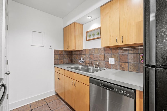 3815 Guadalupe St Unit 112, Austin, TX 78751 - kitchen with freestanding refrigerator, stainless steel dishwasher, light tile patterned flooring, light countertops, and decorative backsplash