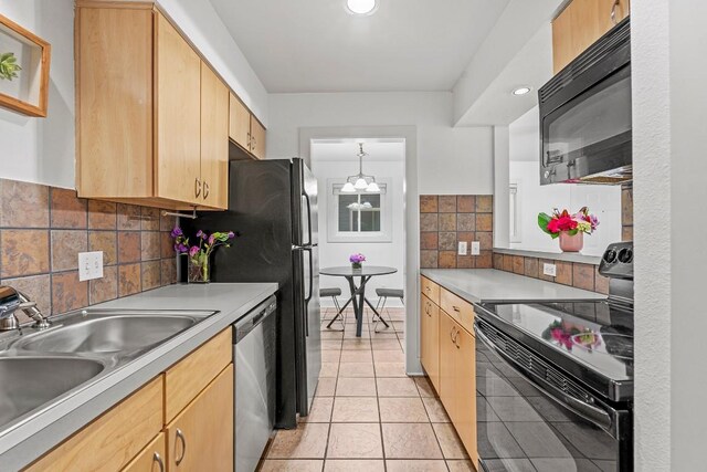 3815 Guadalupe St Unit 112, Austin, TX 78751 - kitchen with black appliances, backsplash, light tile patterned flooring, light brown cabinetry, and light countertops