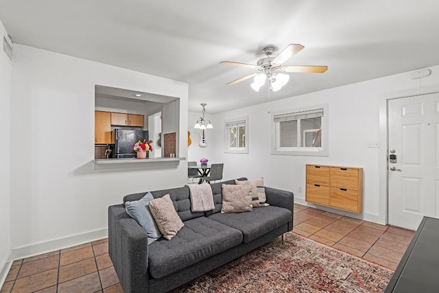 3815 Guadalupe St Unit 112, Austin, TX 78751 - living area with tile patterned flooring, a ceiling fan, and a chandelier