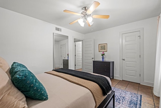 3815 Guadalupe St Unit 112, Austin, TX 78751 - tiled bedroom featuring baseboards and a ceiling fan