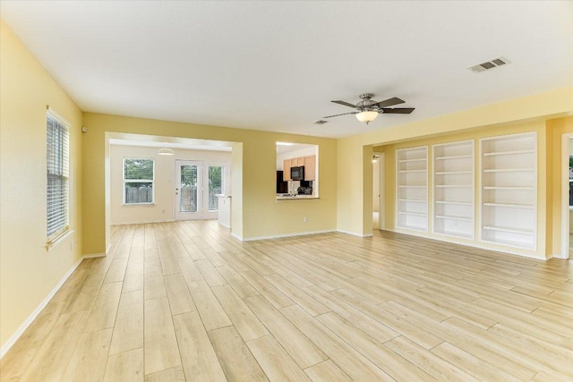 210 Deercreek Ln, Leander, TX 78641 - unfurnished living room with light wood-style floors and a ceiling fan