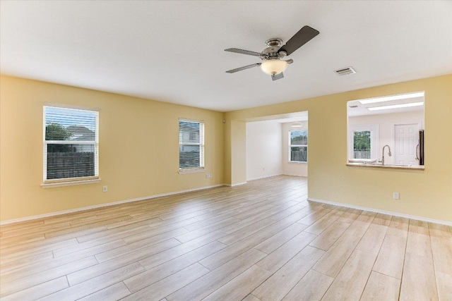 210 Deercreek Ln, Leander, TX 78641 - spare room with light wood finished floors and a ceiling fan