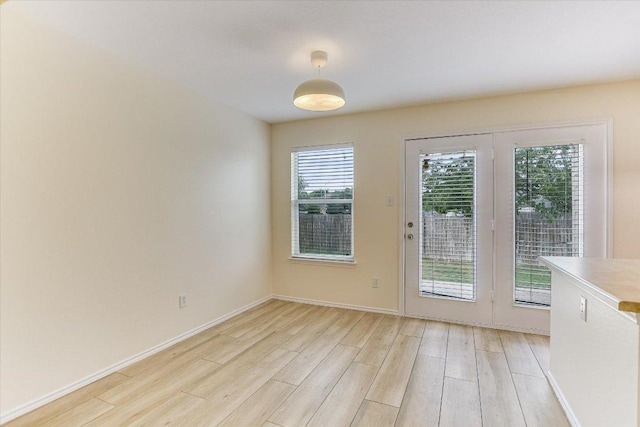 210 Deercreek Ln, Leander, TX 78641 - unfurnished dining area with light wood-type flooring and baseboards