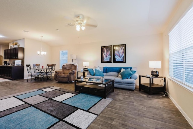 115 San Bernard Trl, Hutto, TX 78634 - living area with ceiling fan, dark wood finished floors, a chandelier, and vaulted ceiling