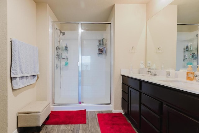 115 San Bernard Trl, Hutto, TX 78634 - full bath with wood finished floors, a shower stall, and double vanity