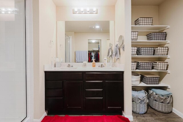 115 San Bernard Trl, Hutto, TX 78634 - full bath with double vanity, tiled shower, wood finished floors, and a closet