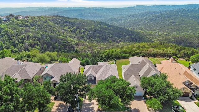 5724 Brittlyns Ct, Austin, TX 78730 - aerial view of residential area with a heavily wooded area and a mountain backdrop