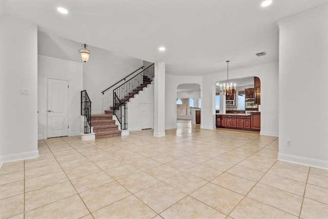 5724 Brittlyns Ct, Austin, TX 78730 - unfurnished living room with arched walkways, stairway, a chandelier, light tile patterned flooring, and recessed lighting