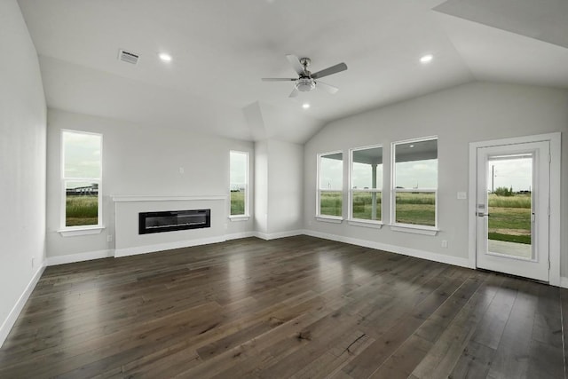 182 Alonzo Dr, Del Valle, TX 78617 - unfurnished living room featuring vaulted ceiling, ceiling fan, dark wood-style flooring, a glass covered fireplace, and recessed lighting