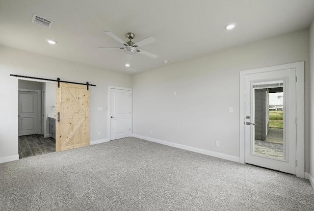 182 Alonzo Dr, Del Valle, TX 78617 - unfurnished bedroom with carpet flooring, a barn door, recessed lighting, ensuite bath, and a ceiling fan