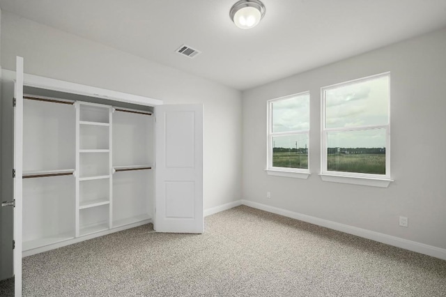 182 Alonzo Dr, Del Valle, TX 78617 - unfurnished bedroom with carpet flooring, vaulted ceiling, and a closet