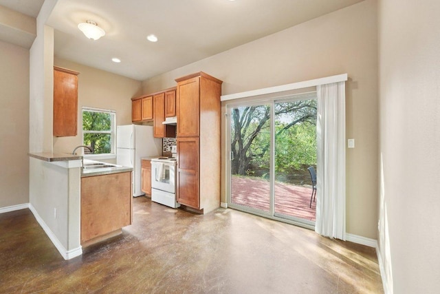 14613 Branding Iron Pass, Austin, TX 78734 - kitchen with white appliances, finished concrete flooring, a peninsula, recessed lighting, and light countertops