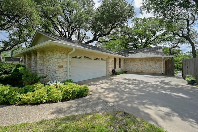 11001 Spicewood Club Dr, Austin, TX 78750 - view of property exterior featuring stone siding, an attached garage, concrete driveway, and roof with shingles