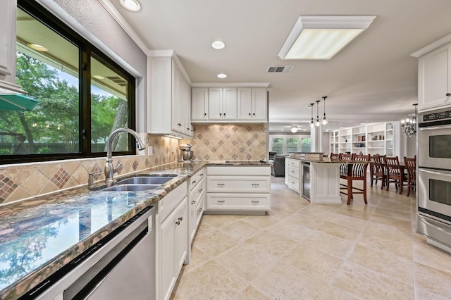 11001 Spicewood Club Dr, Austin, TX 78750 - kitchen featuring appliances with stainless steel finishes, decorative backsplash, dark stone counters, white cabinets, and recessed lighting