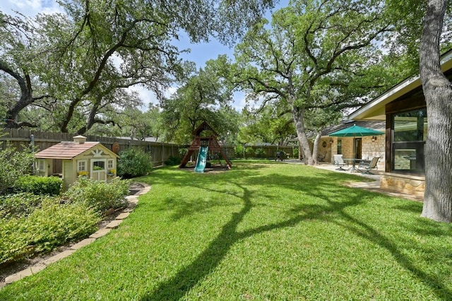 11001 Spicewood Club Dr, Austin, TX 78750 - fenced backyard featuring a playground, an outdoor structure, and a patio area