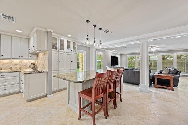 11001 Spicewood Club Dr, Austin, TX 78750 - kitchen featuring open floor plan, dark stone counters, tasteful backsplash, recessed lighting, and white cabinetry