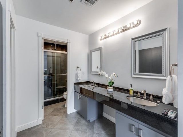 40 N Interstate 35 Unit 2D1, Austin, TX 78701 - bathroom with double vanity, an enclosed shower, and tile patterned floors