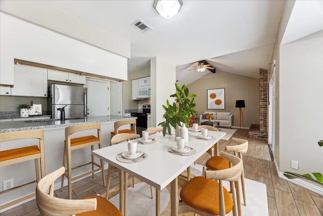 508 Buffalo Pass, Round Rock, TX 78681 - dining room with a ceiling fan, vaulted ceiling, and light wood-type flooring