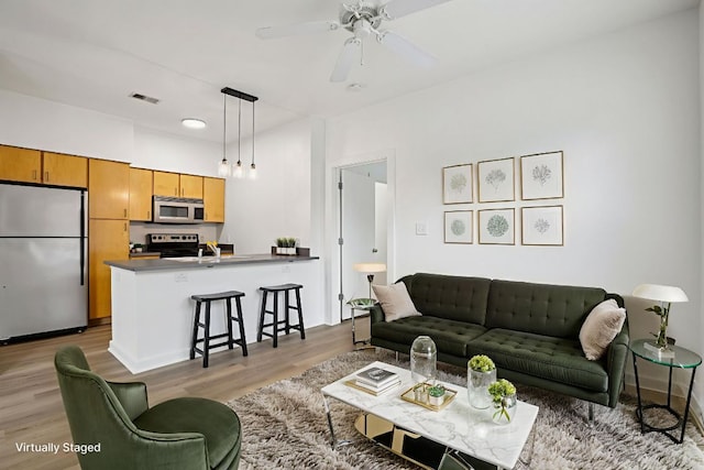 1201 Grove Blvd Unit 1502, Austin, TX 78741 - living area with light wood-style floors and ceiling fan