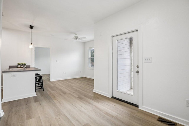 1201 Grove Blvd Unit 1502, Austin, TX 78741 - unfurnished living room featuring a ceiling fan and wood finished floors