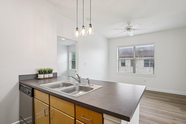 1201 Grove Blvd Unit 1502, Austin, TX 78741 - kitchen featuring stainless steel dishwasher, dark countertops, a peninsula, ceiling fan, and wood finished floors
